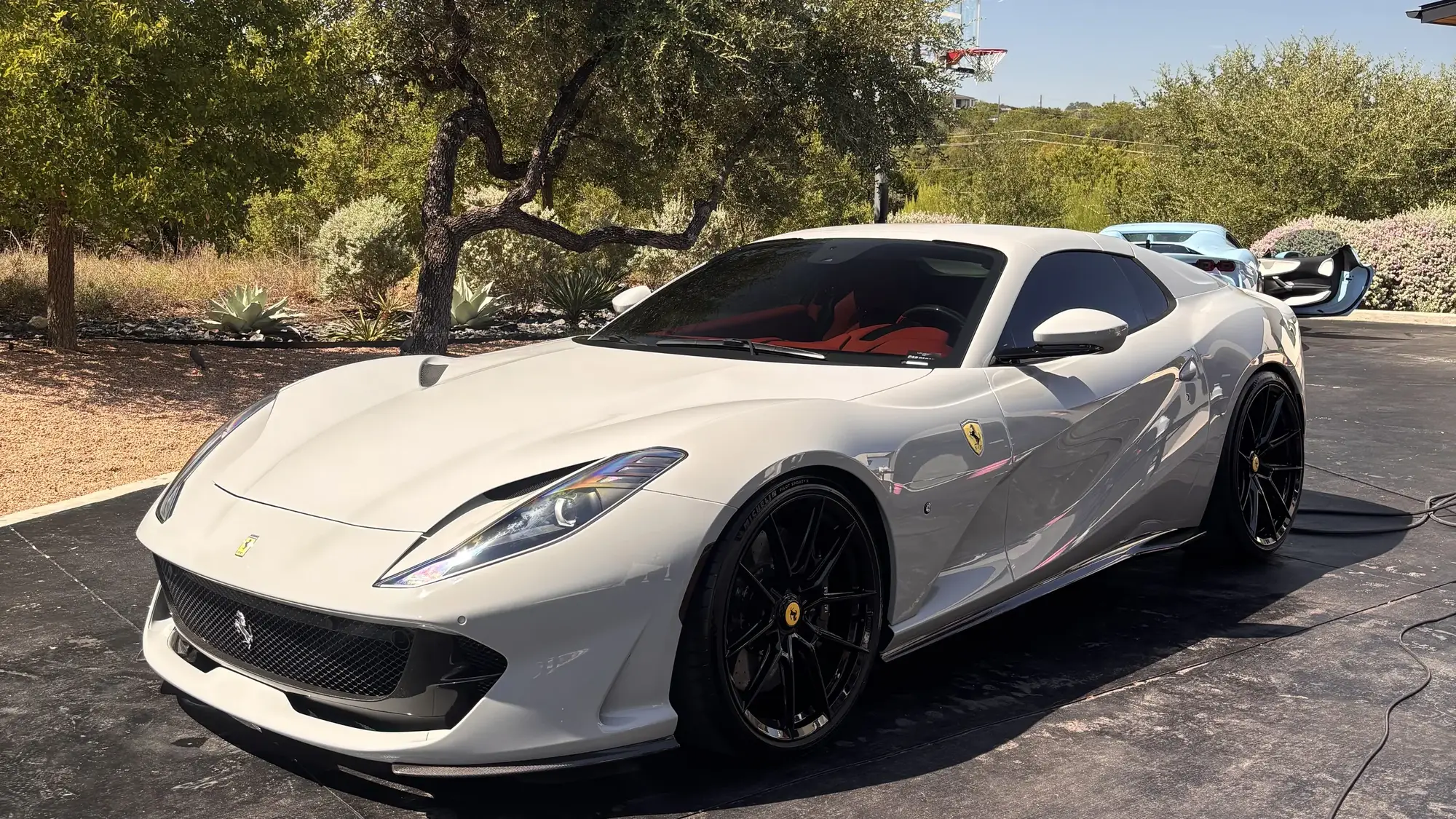 White Ferrari 812 Superfast detailed on a Hill Country driveway