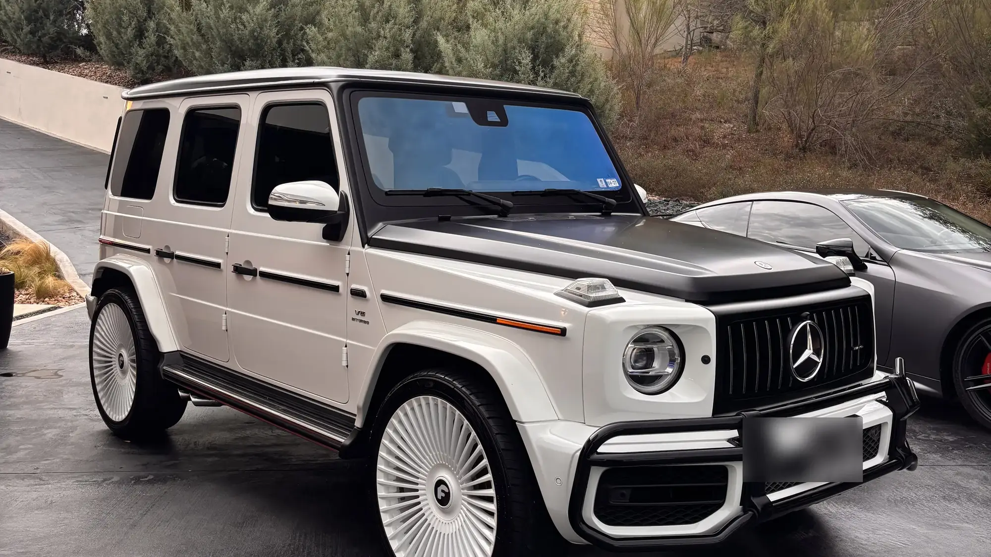White Mercedes-AMG G-Class on a Hill Country driveway